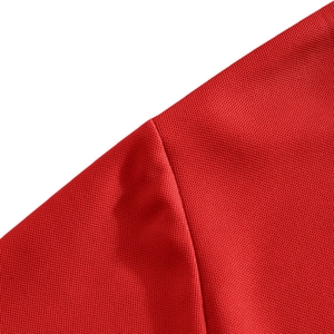 Macro shot of red breathable mesh polo shirt fabric texture with high-quality stitching