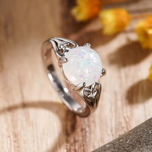 Elegant silver ring with round opal stone and heart hollow design on side band