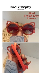 Detail of red glitter cat-ear children sunglasses with grey lenses and UV protection