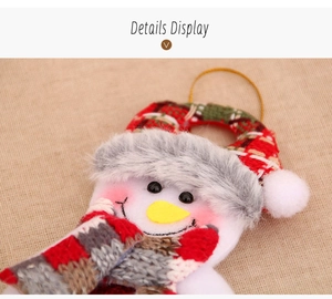 Close-up of plush snowman ornament with knitted scarf and hat for Christmas decor
