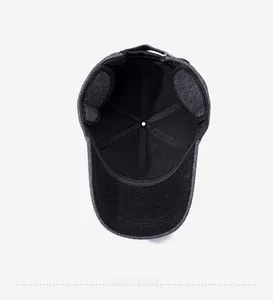 Detail of warm dark grey wool baseball cap showing black fleece lining and metal buckle