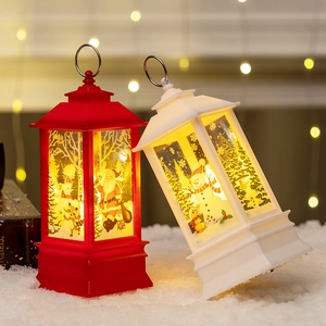 Christmas lantern ornaments with Santa and Snowman prints in warm LED glow