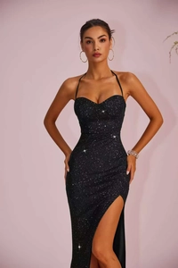 Detail view of elegant black sequin evening gown featuring high slit and slim fit design