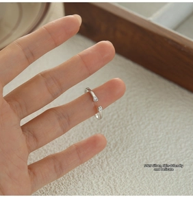 Detailed view of S925 silver cat paw ring with sparkling cubic zirconia on a finger