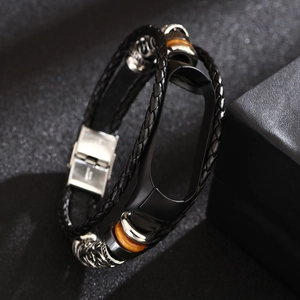 Close-up of black braided leather strap with metal beads and wooden accents for smartwatches
