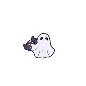 Close-up of cute white ghost enamel pin holding a purple polka dot candy for Halloween