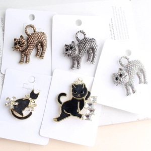 Detail of five cat brooches featuring sparkling rhinestones and colorful enamel finishes