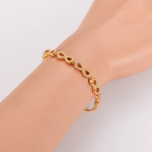 Elegant gold infinity link bracelet with pavé cubic zirconia on mannequin arm