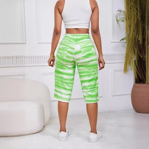 Women's green and white tie-dye casual mid-length denim shorts shown from a back view
