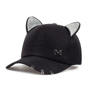Detail of cute cat ear baseball cap with sparkling rhinestones and metal ring accents
