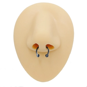 Detail view of black and white marble horseshoe nose ring on silicone nose model