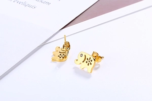 Macro shot of gold elephant stud earrings featuring hollow flower detail and small zircon eye