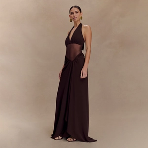 Detail of dark brown halter neck dress with sheer mesh waist and pleated skirt