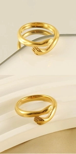 Macro detail of 18k gold plated stainless steel hug ring showing the hands design