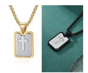 Detailed comparison of gold and black rectangular cross pendant necklaces on textures