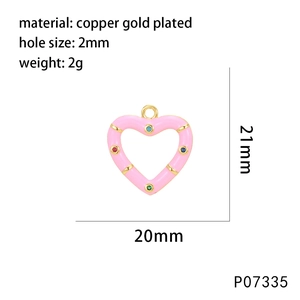 Detail of pink enamel heart pendant in copper gold plating with colorful micro zircons
