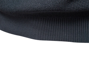 Detailed close-up of dark grey ribbed knit cuff showing high-quality fabric texture