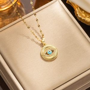 Golden Evil Eye pendant necklace with blue and white zircons on a brushed display box