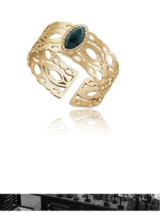Macro detail of vintage 18K gold plated hollow ring with inlaid oval turquoise stone