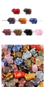 Macro shot of assorted mini natural crystal pig carvings in various colorful gemstones
