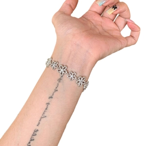 Silver flower lace bracelet with sparkling rhinestones on woman's wrist in a main product view