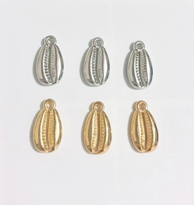 Detailed view of silver and gold plated shell pendants for DIY jewelry crafting