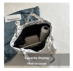 Top view of white tote bag interior showing capacity for umbrella, wallet, and phone