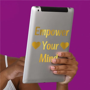 Detail of gold Empower Your Mind sticker on iPad back with purple background