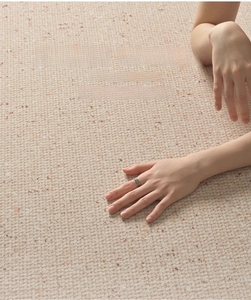 Close-up of beige waterproof carpet showing soft texture and antibacterial fabric