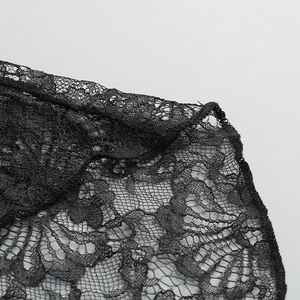 Close-up of intricate black lace floral embroidery and fine mesh texture detail