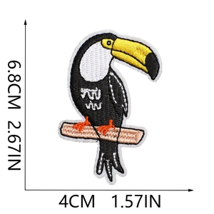 Close-up of a colorful toucan embroidered patch showing precise size and dimensions