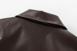 Close-up of the collar and back detail on this dark brown faux leather bomber jacket