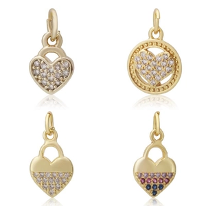 Close-up of four gold heart charms with cubic zirconia for DIY jewelry making