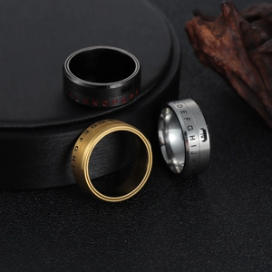 Detailed view of rotating titanium steel rings with engraved letters in three colors
