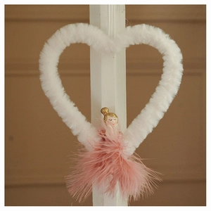 Detail of plush heart ornament with pink feathers and golden hair fairy figure