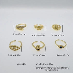 Detail of six adjustable 18K gold-plated rings with Evil Eye and Hamsa Hand charms