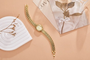 Detailed 45-degree angle of vintage style gold women's watch on a decorative display stand