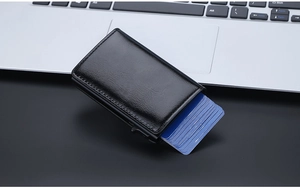 Detail view of black oil wax leather card holder with automatic RFID pop-up mechanism