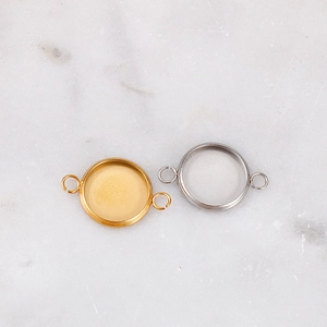 Macro view of gold and silver stainless steel round gemstone base connectors for DIY jewelry