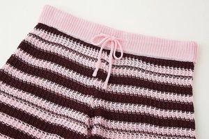 Detailed close-up of striped crochet knit shorts featuring an adjustable drawstring waist