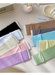 Detail of colorful velvet cotton socks in ten pastel shades with branded card packaging