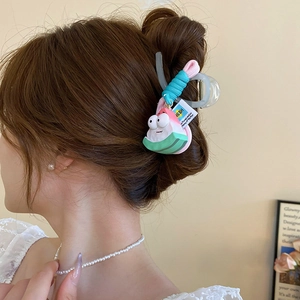 Close-up of a cute pink starfish claw clip worn by a woman with a sweet hairstyle
