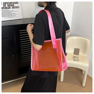 Detail view of the large capacity orange transparent PVC tote bag with pink trim