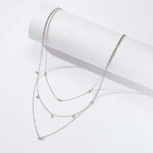 Three-layer S925 sterling silver necklace with star pendant and metallic beads on white stand