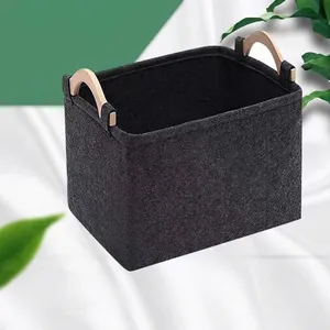 Dark grey felt storage bin for cat toys with wooden handles and paw print design