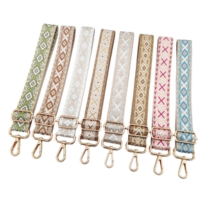 Adjustable jacquard bag strap with geometric diamond pattern and gold hardware