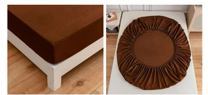 Detail view of dark brown fitted sheet with all-around elastic band for mattress