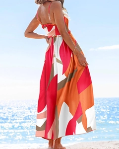 Detail of bohemian spaghetti strap maxi dress with backless design and geometric print