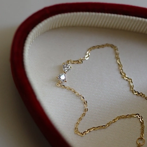 Close-up of S925 silver bow bracelet with heart zirconia in a red velvet jewelry box