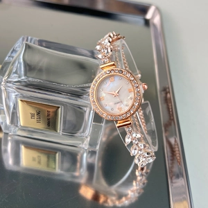 Rose gold quartz watch with mermaid leaf bracelet and shimmering diamond accents